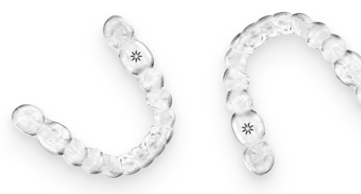 2 invisalign clear aligners with the invisalign logo on them